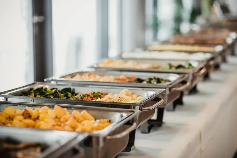Catering buffet with chafing dishes of hot food